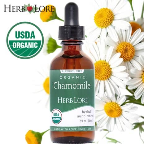 3 Herb Lore Chamomile Tincture bottle with blooming chamomile flowers in the background and USDA Organic seal