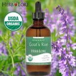 Herb Lore Goat’s Rue Tincture bottle shown in front of blooming goat’s rue flowers with USDA Organic badge