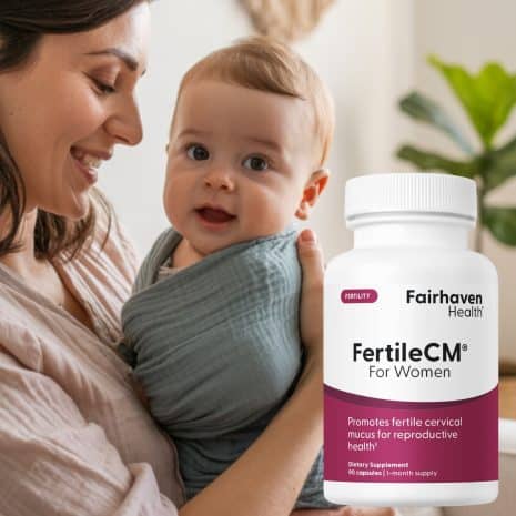 CMLifestyle Smiling mother holding baby wrapped in a soft teal sling, with FertileCM bottle shown in the foreground.